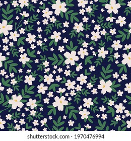 Seamless vintage pattern. Dark blue background. Large and small white flowers. green leaves. Vector texture. fashionable print for textiles and wallpaper.