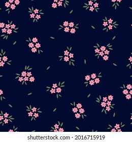 Seamless vintage pattern. dark blue background . small pink flowers. green leaves . vector texture. trend print for textiles.