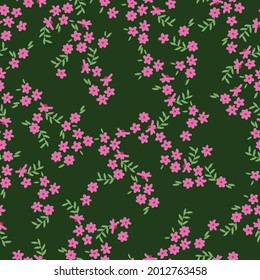 Patrón vintage sin foco. fondo verde. flores pequeñas rosas brillantes, hojas verdes claras. textura vectorial. impresión de tendencias para textiles y superficies