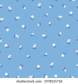 Seamless vintage pattern. light blue background. small white flowers . dark blue leaves. vector texture. fashionable print for textiles and wallpaper.