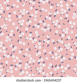seamless vintage pattern. light pink background. small white flowers. dark blue leaves. vector texture. fashionable print for textiles and wallpaper.