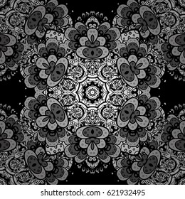 Seamless vintage pattern on black background with white elements and with white doodles. Christmas, snowflake, new year.