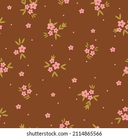 Seamless vintage pattern. Pink flowers and dots, golden leaves. Brown background. vector texture. fashionable print for textiles, wallpaper and packaging.