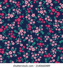 Seamless vintage pattern. Small pink and fuchsia flowers, green leaves. blue background. vector texture. fashionable print for textiles, wallpaper and packaging.