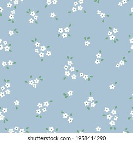 seamless vintage pattern. small white flowers on a blue background. vector texura. spring fashion print for textiles and wallpaper.