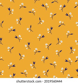 Seamless vintage pattern. small white flowers and dark blue leaves on a yellow background. vector texture. trend print for textiles and wallpaper.