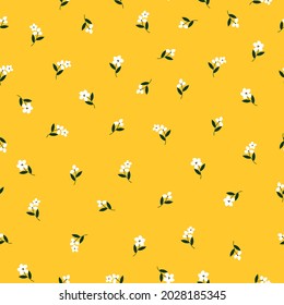 Seamless vintage pattern. small white flowers and dark green leaves on a yellow background. vector texture. trend print for textiles and wallpaper.