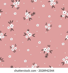 Seamless vintage pattern. small white flowers and dots, brown leaves on a pink background. vector texture. trend print for textiles.