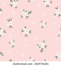 Seamless vintage pattern . small white flowers and dots, green leaves on a light pink background. vector texture. a trend template for fashionable prints.