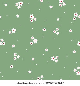 Seamless vintage pattern. small white flowers and dots on a green background. vector texture. trend print for textiles and wallpaper.