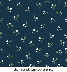 Seamless vintage pattern. small white flowers ,green leaves on a dark blue background. vector texture. trend print for textiles and wallpaper.
