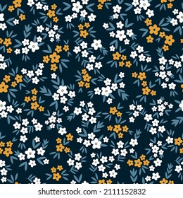 Seamless vintage pattern. Small white and orange flowers, green leaves. Dark blue background. vector texture. fashionable print for textiles, wallpaper and packaging.