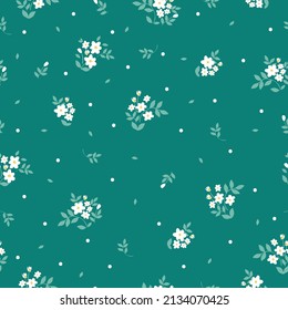 Nahtloses Vintage-Muster. Kleine weiße Blumen und Punkte, hellgrüne Blätter. Türkisfarbener Hintergrund. Vektorstruktur. modischer Druck für Textilien, Tapeten und Verpackungen.