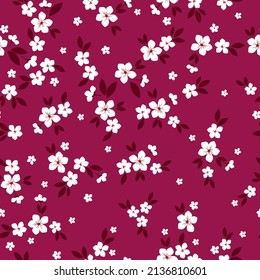 Seamless vintage pattern. Small white flowers and dark leaves. Burgundy background. vector texture. fashionable print for textiles, wallpaper and packaging.