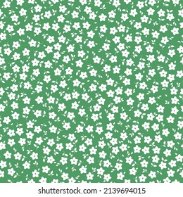 Seamless vintage pattern. Small white flowers and leaves.  green  background. vector texture. fashionable print for textiles, wallpaper and packaging.