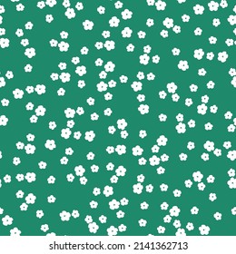 Seamless vintage pattern. Small white flowers . green background. vector texture. fashionable print for textiles, wallpaper and packaging.