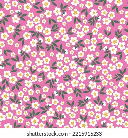 seamless vintage pattern. small white flowers and green leaves. pink background. vector texture. fashionable print for textiles and wallpaper.