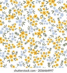 Seamless vintage pattern. small yellow and blue flowers, green leaves on a white background. vector texture. trend print for textiles and wallpaper.