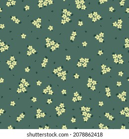 Seamless vintage pattern. small yellow flowers on a green background. vector texture. fashionable print for textiles and wallpaper.