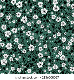 Seamless vintage pattern. White and black flowers, leaves. Green background. vector texture. fashionable print for textiles, wallpaper and packaging.