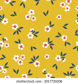 Seamless vintage pattern. white flowers and blue leaves on a yellow background. vector texture. trend print for textiles.