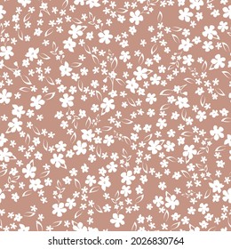Seamless vintage pattern. white flowers and leaves on a beige background. vector texture. trend print for textiles and wallpaper.