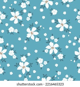 seamless vintage pattern. white flowers, dark blue leaves. blue  background. vector texture. fashionable print for textiles and wallpaper.
