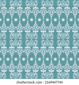 Patrón vintage sin foco. La decoración es de color blanco sobre un fondo turquesa oscuro.