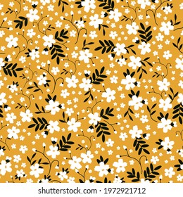 Seamless vintage pattern. yellow background. white flowers. black leaves. vector texture. trend print for textiles and wallpaper.