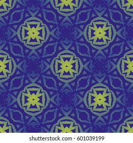 Seamless violet and light green ethnic pattern made of dots. A pockmarked background of geometric shapes and stylized plant elements.