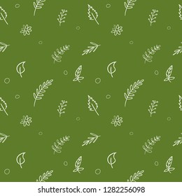 Seamless white pattern plants and leaves on a green background abstraction in the form of a sketch.