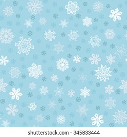 Seamless winter light blue background with snowflakes for Christmas and New Year holidays