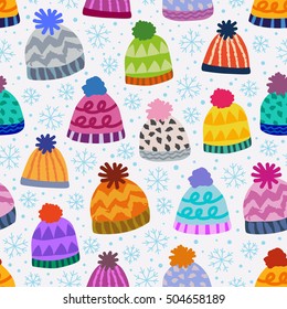 seamless winter pattern with caps and snowflakes