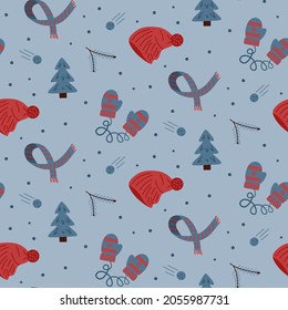 Seamless winter pattern, clothes, branches, Christmas tree on blue background. Color vector illustration.