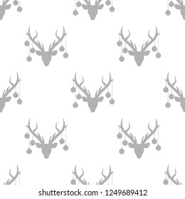 seamless winter pattern with grey silhouette of deer head with antlers and christmas tree toy balls on horns. vector flat Christmas ornament on white background