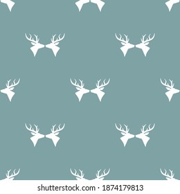 seamless winter pattern with   silhouette of deer head with antlers. vector flat Christmas ornament on powder blue background. winter reindeer texture.