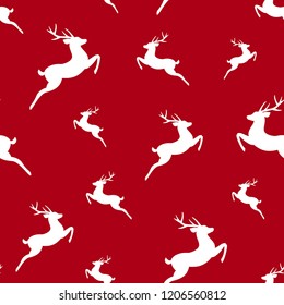 seamless winter pattern with  white silhouette of jumping deer with antlers. vector flat Christmas ornament on red background