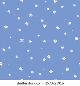The seamless winter pattern with white snowflakes on a blue background. Vector.