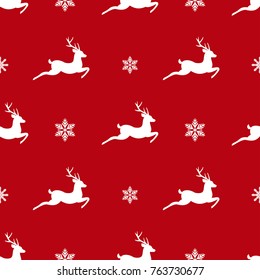 seamless winter pattern with white snowflakes and deers with antlers. vector flat Christmas ornament on red background. winter reindeer texture.