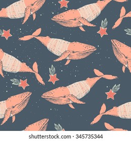 Seamless winter vector pattern. Whales in knitting sweater and stars.