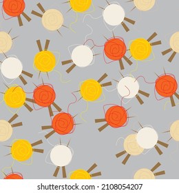 Seamless with yarn and knitting needles on the grey background. Pattern for theme of handmade