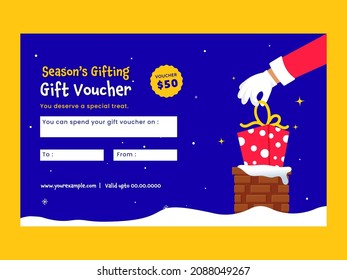 Season's Gift Voucher Design With Santa Hand Put A Gift Box Into Chimney On Blue Snowfall Background.