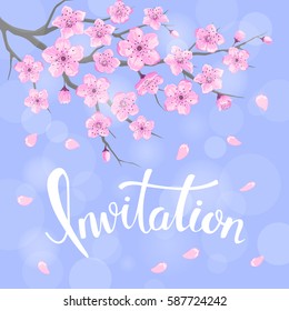 Seasons greeting background with cherry blossoms flowers branches on blue backdrop with bokeh and hand written Invitation word 