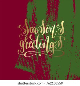 season's greetings - gold hand lettering on green and purple brush stroke background, vector illustration