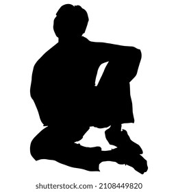 Seated young man in casual pose. Black silhouette on white background.