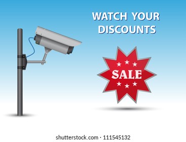Security cctv camera with open lens and wires on pole. Green sticker with text Sale and au above text Watch Your Discounts.