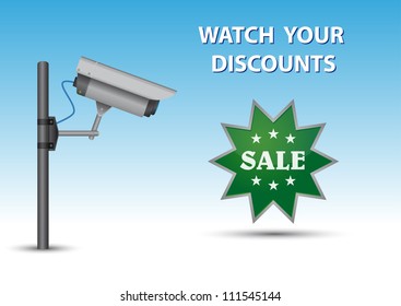 Security cctv camera with open lens and wires on pole. Green sticker with text Sale and au above text Watch Your Discounts.