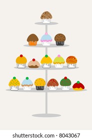 A selection of delicious cupcakes and muffins presented on multi-tiered display stand.