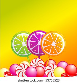 Selection of lolly pops and sweets on a citrus coloured background