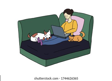 Self isolation girl working and resting at home, lies on the couch, with a laptop, with pets